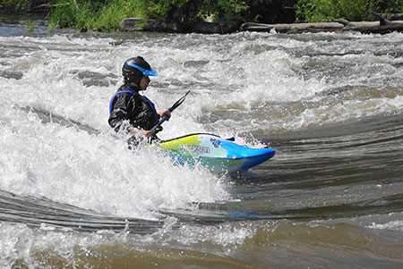 Jessica in a kayak in whitewater.