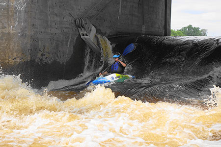 Jessica in a kayak in whitewater.