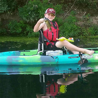 Donovan standing in his Jackson Kayak Skipper.