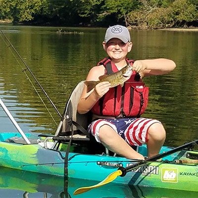 Donovan standing in his Jackson Kayak Skipper.