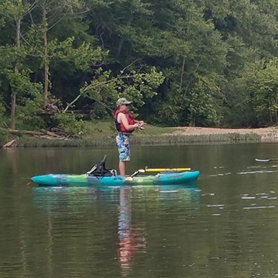 Donovan standing in his Jackson Kayak Skipper.